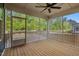 Relaxing screened porch with wood flooring, ceiling fan, and scenic wooded views at 3866 Keohane Dr, Durham, NC 27705