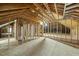 Large unfinished attic with exposed wood framing, plywood flooring, and partially insulated walls at 406 N Wakefield St, Zebulon, NC 27597