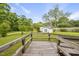 View of a backyard featuring a small white outbuilding and a wooden deck at 406 N Wakefield St, Zebulon, NC 27597