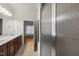 Bathroom with double sinks, neutral tile, and glass-enclosed shower at 406 N Wakefield St, Zebulon, NC 27597