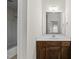 Bathroom with marble countertops, dark wood cabinets, and updated fixtures at 406 N Wakefield St, Zebulon, NC 27597