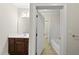 Bathroom with marble countertops, dark wood cabinets, and updated fixtures at 406 N Wakefield St, Zebulon, NC 27597