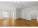 A primary bedroom featuring hardwood floors, a ceiling fan, and closet space at 406 N Wakefield St, Zebulon, NC 27597