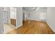 A primary bedroom leading to an ensuite bath, featuring hardwood floors, a ceiling fan, and natural light at 406 N Wakefield St, Zebulon, NC 27597
