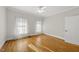 Bright bedroom with hardwood floors, ceiling fan, and ample natural light at 406 N Wakefield St, Zebulon, NC 27597