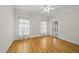 Bright bedroom with hardwood floors, ceiling fan, and access to back porch at 406 N Wakefield St, Zebulon, NC 27597