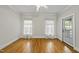 Bright bedroom with hardwood floors, ceiling fan, and access to back porch at 406 N Wakefield St, Zebulon, NC 27597