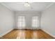 Bright bedroom with hardwood floors, ceiling fan, and ample natural light at 406 N Wakefield St, Zebulon, NC 27597