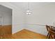 An empty dining room with hardwood floors and a hanging light fixture at 406 N Wakefield St, Zebulon, NC 27597