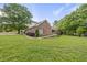 A charming brick home with a ramp leading to the entrance surrounded by a lush green lawn at 406 N Wakefield St, Zebulon, NC 27597
