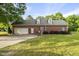 An attractive brick home featuring an attached garage and a well-manicured lawn at 406 N Wakefield St, Zebulon, NC 27597