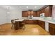 An open kitchen featuring wood cabinets, a breakfast bar, and updated, stainless steel appliances at 406 N Wakefield St, Zebulon, NC 27597