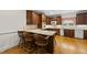 Traditional kitchen featuring wood cabinets, a breakfast bar with seating, and hardwood floors at 406 N Wakefield St, Zebulon, NC 27597