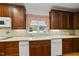 A kitchen sink featuring wood cabinets and a view through the window to the exterior at 406 N Wakefield St, Zebulon, NC 27597