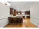 A kitchen featuring wood cabinets, a breakfast bar with seating, and hardwood floors at 406 N Wakefield St, Zebulon, NC 27597