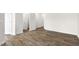 Spacious living area showcasing wood-look flooring, neutral walls, and seamless flow to other living spaces at 408 Ember St, Sanford, NC 27330