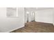 Open living space offers wood-look flooring, neutral walls, and seamless flow to other living spaces at 408 Ember St, Sanford, NC 27330