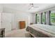 Bedroom featuring a wood dresser, a bed, three windows and a ceiling fan at 409 Summit Trail Dr, Hillsborough, NC 27278