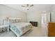 Bright bedroom featuring a ceiling fan, a bed, and two dressers at 409 Summit Trail Dr, Hillsborough, NC 27278