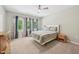 Relaxing bedroom with three windows, curtains and a ceiling fan at 409 Summit Trail Dr, Hillsborough, NC 27278