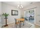 Bright dining area with wood table, chandelier, and sliding glass door to patio at 409 Summit Trail Dr, Hillsborough, NC 27278