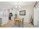 Cozy dining area with a round table, chandelier, and views into the kitchen at 409 Summit Trail Dr, Hillsborough, NC 27278