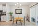 Charming dining area featuring a round table, chandelier, and sliding glass door access at 409 Summit Trail Dr, Hillsborough, NC 27278