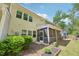 A two-story home's exterior showcasing the screened porch, well-maintained lawn, and lush landscaping at 409 Summit Trail Dr, Hillsborough, NC 27278