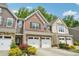 View of townhomes showcasing brick and siding exteriors with attached garages at 409 Summit Trail Dr, Hillsborough, NC 27278