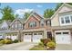 Well-maintained townhomes with inviting curb appeal, landscaping, and attached garages at 409 Summit Trail Dr, Hillsborough, NC 27278