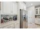 Bright kitchen featuring stainless steel appliances, white cabinetry, and modern countertops at 409 Summit Trail Dr, Hillsborough, NC 27278