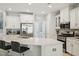 Bright kitchen boasts stainless steel appliances, white cabinets, and a large island with seating for casual dining at 409 Summit Trail Dr, Hillsborough, NC 27278