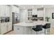 Modern kitchen featuring a large island, stainless steel appliances, and bright white cabinetry at 409 Summit Trail Dr, Hillsborough, NC 27278