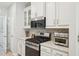 Modern kitchen featuring stainless steel appliances, white cabinetry, and stylish countertops at 409 Summit Trail Dr, Hillsborough, NC 27278