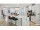 Bright kitchen boasts stainless steel appliances, white cabinets, and a large island with seating for casual dining at 409 Summit Trail Dr, Hillsborough, NC 27278