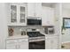 Modern kitchen with stainless steel appliances, a gas range, and a stylish tile backsplash at 409 Summit Trail Dr, Hillsborough, NC 27278