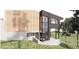 Modern exterior with wood and dark grey accents and walls of windows at 4120 Picardy Dr, Raleigh, NC 27612