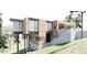 Modern exterior with wood and dark grey accents and walls of windows and concrete stairs at 4120 Picardy Dr, Raleigh, NC 27612