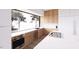 Modern kitchen featuring stainless steel appliances, wood cabinetry, and large windows at 4120 Picardy Dr, Raleigh, NC 27612