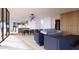 Open-concept living space with light wood floors, modern furniture, and kitchen view at 4120 Picardy Dr, Raleigh, NC 27612