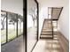 Modern staircase with wood steps, glass walls and an abundance of natural light at 4120 Picardy Dr, Raleigh, NC 27612