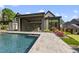 Beautiful backyard with a sparkling pool, covered patio, and putting green at 4139 Rockingham Dr, Raleigh, NC 27609