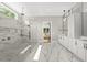 Stunning bathroom showcasing a glass shower with marble tile, and a bright window at 4139 Rockingham Dr, Raleigh, NC 27609