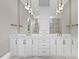 Elegant bathroom featuring a double vanity, marble countertops, and modern pendant lighting at 4139 Rockingham Dr, Raleigh, NC 27609