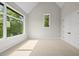 Bright bedroom featuring large windows with scenic views and neutral carpet at 4139 Rockingham Dr, Raleigh, NC 27609
