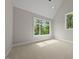 Cozy bedroom with neutral walls and soft carpet and a view of outside at 4139 Rockingham Dr, Raleigh, NC 27609