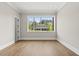 Bright bedroom with hardwood floors, a large window, and an adjoining bathroom at 4139 Rockingham Dr, Raleigh, NC 27609