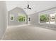 Expansive bedroom with vaulted ceiling, ceiling fan, three windows, and neutral carpet at 4139 Rockingham Dr, Raleigh, NC 27609