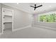 Bright, airy bedroom with neutral walls, plush carpet, ceiling fan, and a walk-in closet at 4139 Rockingham Dr, Raleigh, NC 27609