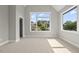 Bright bedroom with neutral walls and flooring, and large windows at 4139 Rockingham Dr, Raleigh, NC 27609